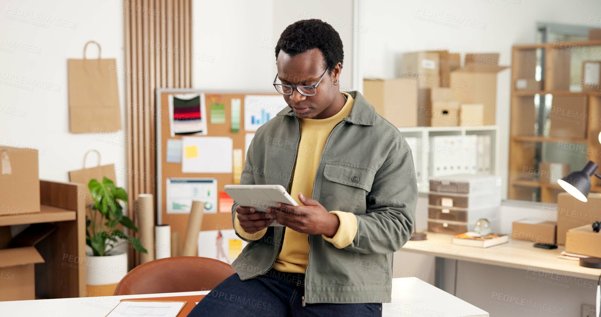 Buy stock photo Ecommerce, research and black man in office with tablet for erp tech in small business workflow. Search, web or entrepreneur on digital app for online sales data, checklist or inventory management