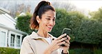 Woman, smile and phone in backyard with social media, watch video and search blog for wellness tips. Happy, mature person and relax outdoor by home with tech, internet and browsing app for vitality.