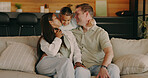 Happy, kiss and parents with child on sofa for bonding, loving relationship and connection. Hug, family home and girl with mom, dad and affection for care, moment and trust for embrace on weekend