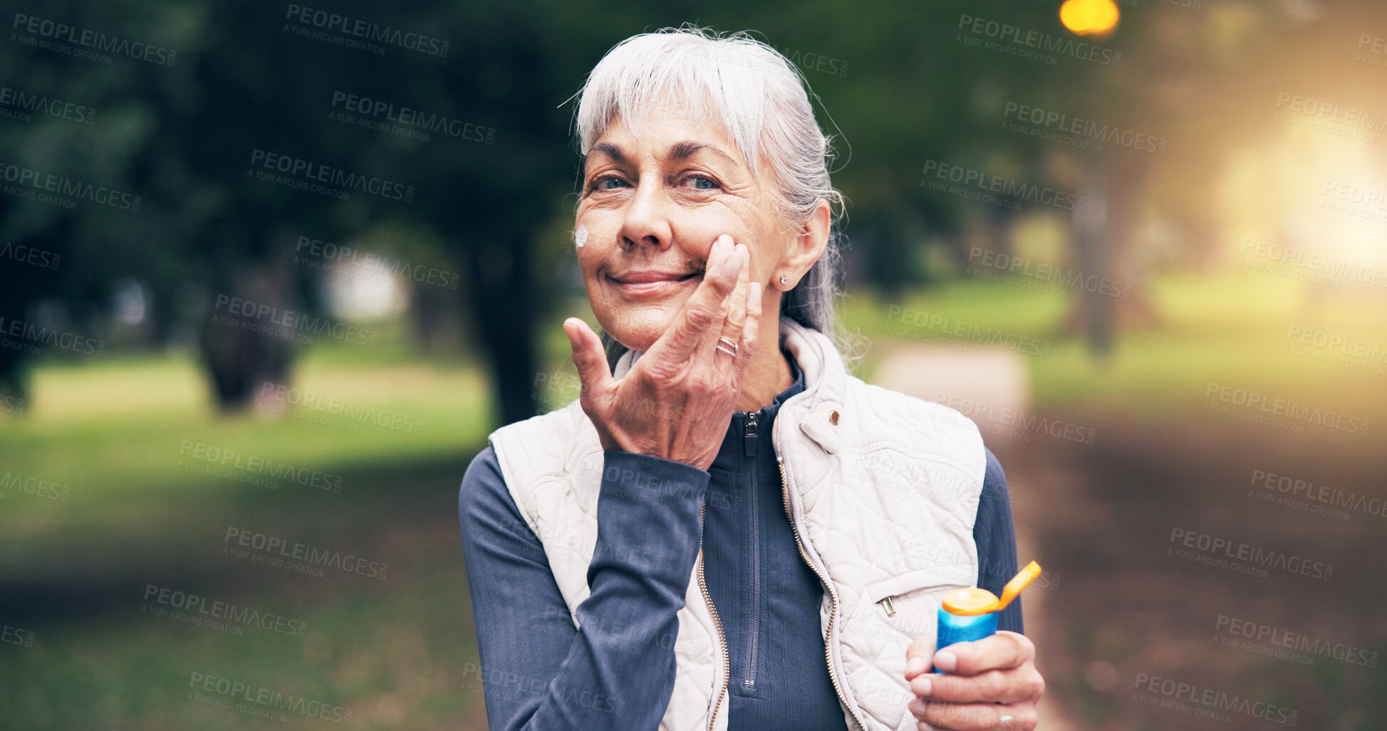 Buy stock photo Fitness, portrait or senior woman with sunscreen, sun safety or damage prevention in nature workout. Happy, wellness or old person with spf cream, UV protection or outdoor application in active aging