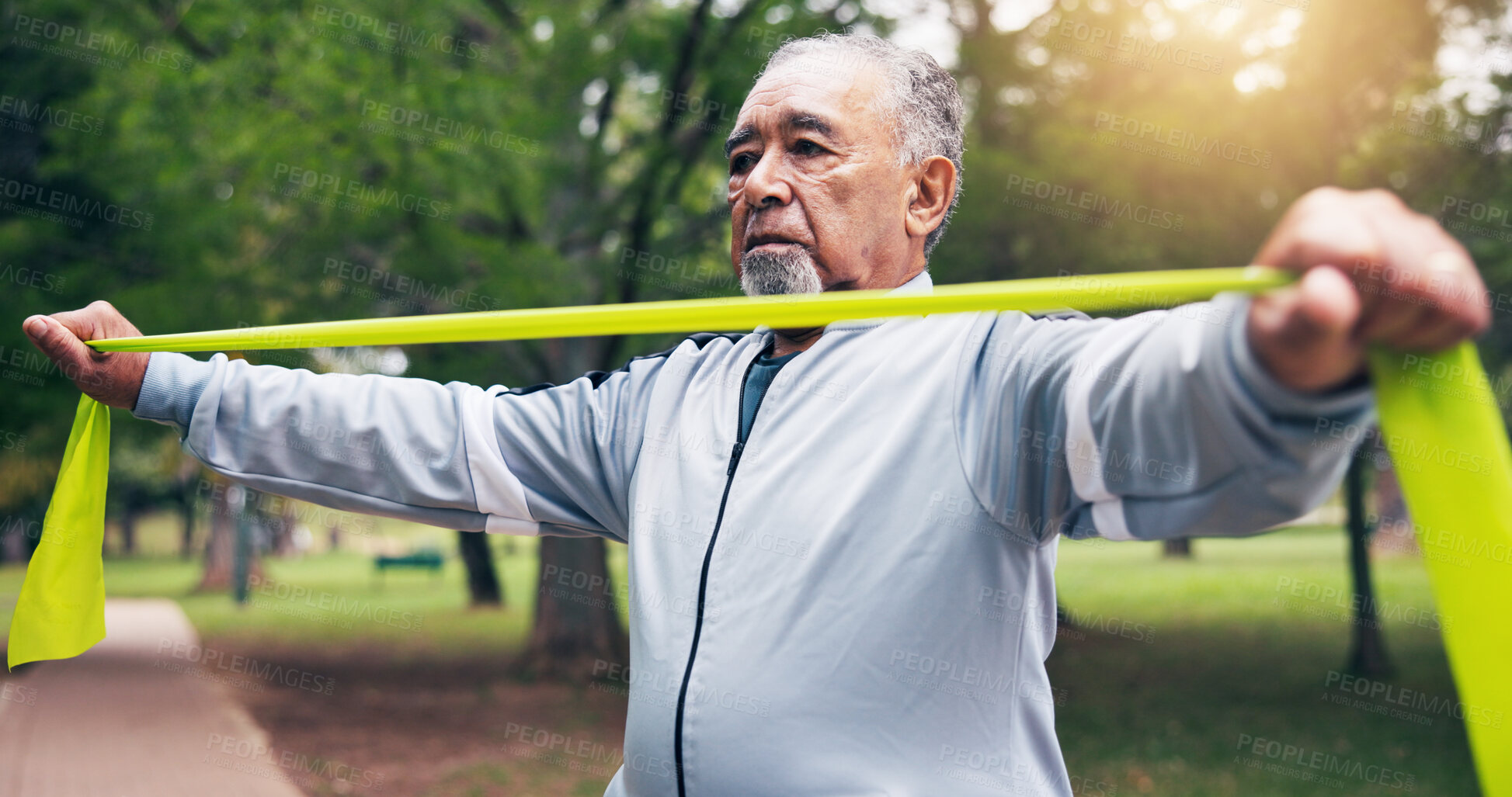 Buy stock photo Senior, man and resistance band in park for outdoor exercise, strength workout or joint tension. Active, elderly or male person stretching with strap for muscle health, training or physical activity