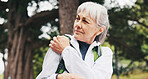 Senior, woman and shoulder pain in woods for hiking, injury or muscle cramp with arthritis. Person, hurt joint or aching bones with calcium deficiency, health issue or rotator cuff tear from exercise