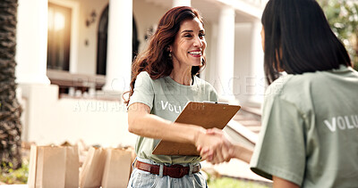 Buy stock photo Clipboard, volunteer or happy woman with handshake for charity, checklist or donation campaign. Female person, activist and shaking hands with smile for community service or outdoor outreach together