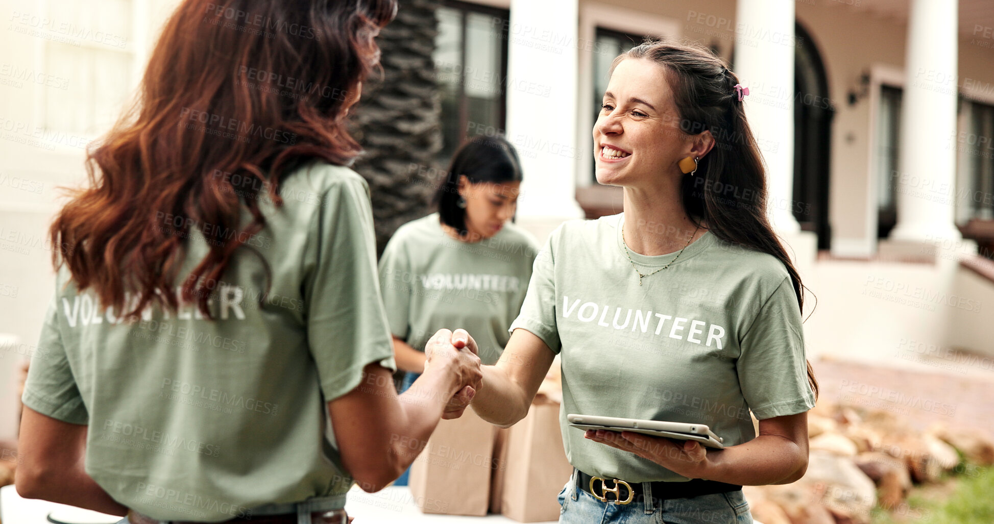 Buy stock photo Woman, handshake and tablet outdoor for volunteering, welcome and thank you for community service. Smile, people or shaking hands with digital for greeting, recognition and success of welfare project