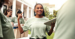 Woman, volunteer and team at event with tablet, sign up and appoint task for community outreach. Smile, coordinator and people with tech for charity, participation and job allocation for distribution