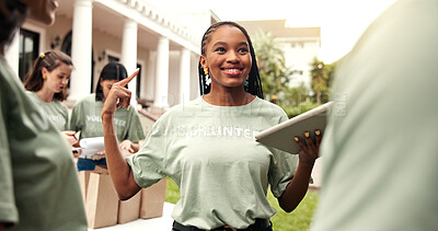 Buy stock photo Woman, volunteer and team at event with tablet, sign up and appoint task for community outreach. Smile, coordinator and people with tech for charity, participation and job allocation for distribution