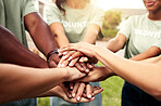 Volunteer, team and unity with hand stack, outdoor and solidarity for fundraising goals and charity. People, together and motivation for community service, collaboration and social responsibility