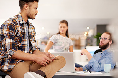 Buy stock photo Business people, conversation and planning in office, designers and creativity for project. Employees, group and discussion in workplace, laptop and brainstorming for proposal, feedback and ideas