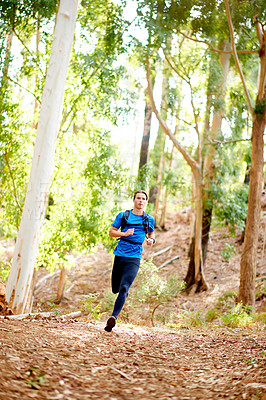 Buy stock photo Running, fitness and man in woods, training and cardio with endurance, challenge and wellness. Healthy person, athlete and runner in forest, practice and hobby with energy, exercise and workout