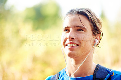 Buy stock photo Runner, outdoor and man with fitness, music and smile with wellness, listening to audio and space. Person, earphones and athlete in park, workout and training with exercise and motivation podcast