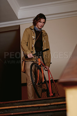 Buy stock photo Bicycle, travel and man in apartment by stairs for eco friendly, transportation or college commute. Below, male student and bike for university, carbon footprint and academy for morning cycling