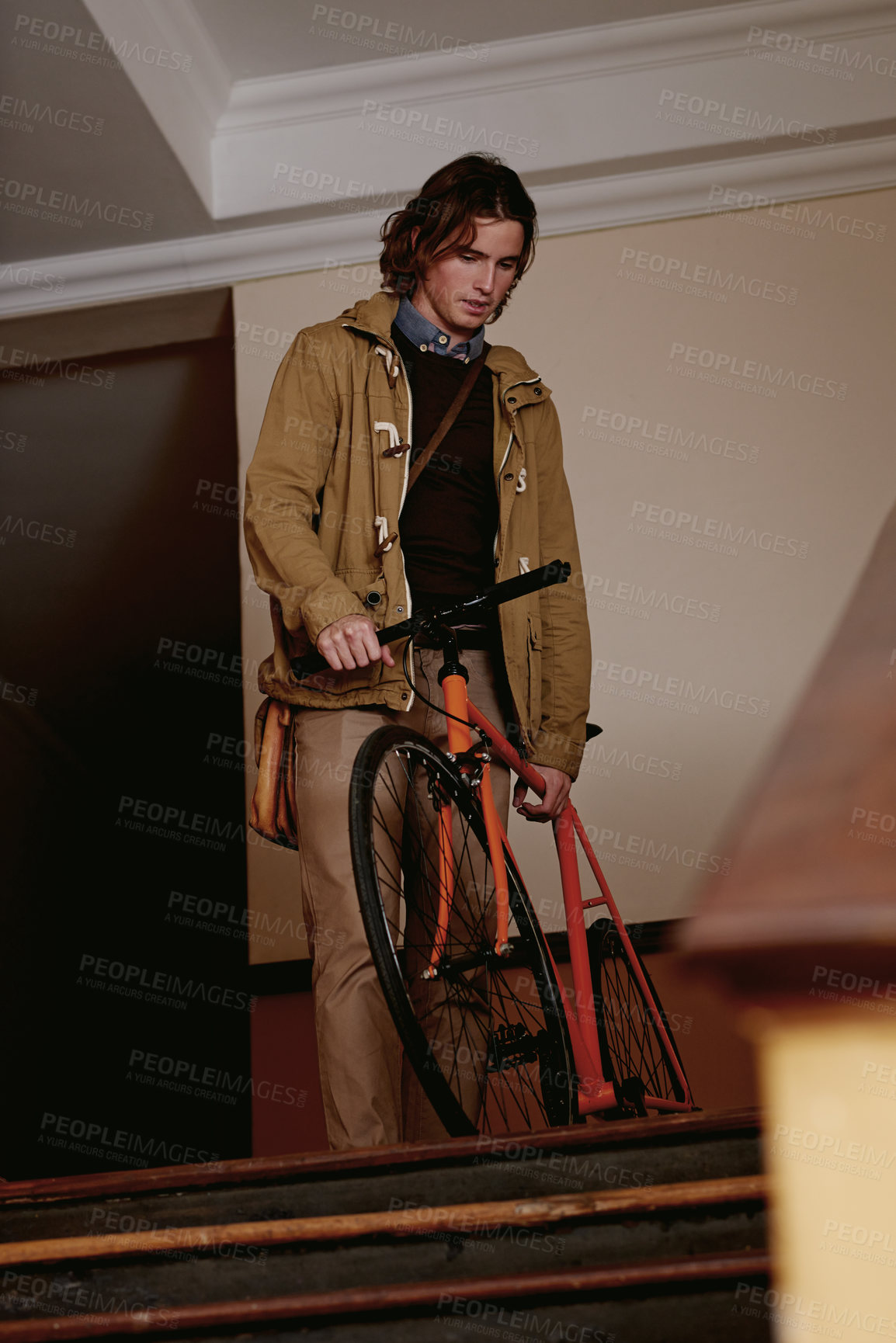 Buy stock photo Bicycle, travel and man in apartment by stairs for eco friendly, transportation or college commute. Below, male student and bike for university, carbon footprint and academy for morning cycling