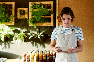 Buy stock photo Restaurant, waiter and man on tablet for orders, inventory and stock with seasoning options. Coffee shop, small business and male barista with touchscreen for managing sales and store service in cafe