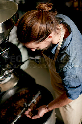 Buy stock photo Above, man and beans in coffee roastery for inspection, quality control or roasting for distribution. Master roaster, machine or prepare product in workshop for export, small business or supply chain