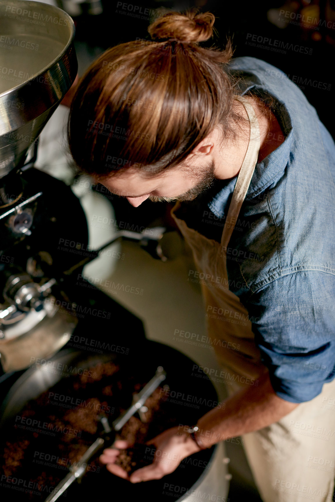 Buy stock photo Above, man and beans in coffee roastery for inspection, quality control or roasting for distribution. Master roaster, machine or prepare product in workshop for export, small business or supply chain