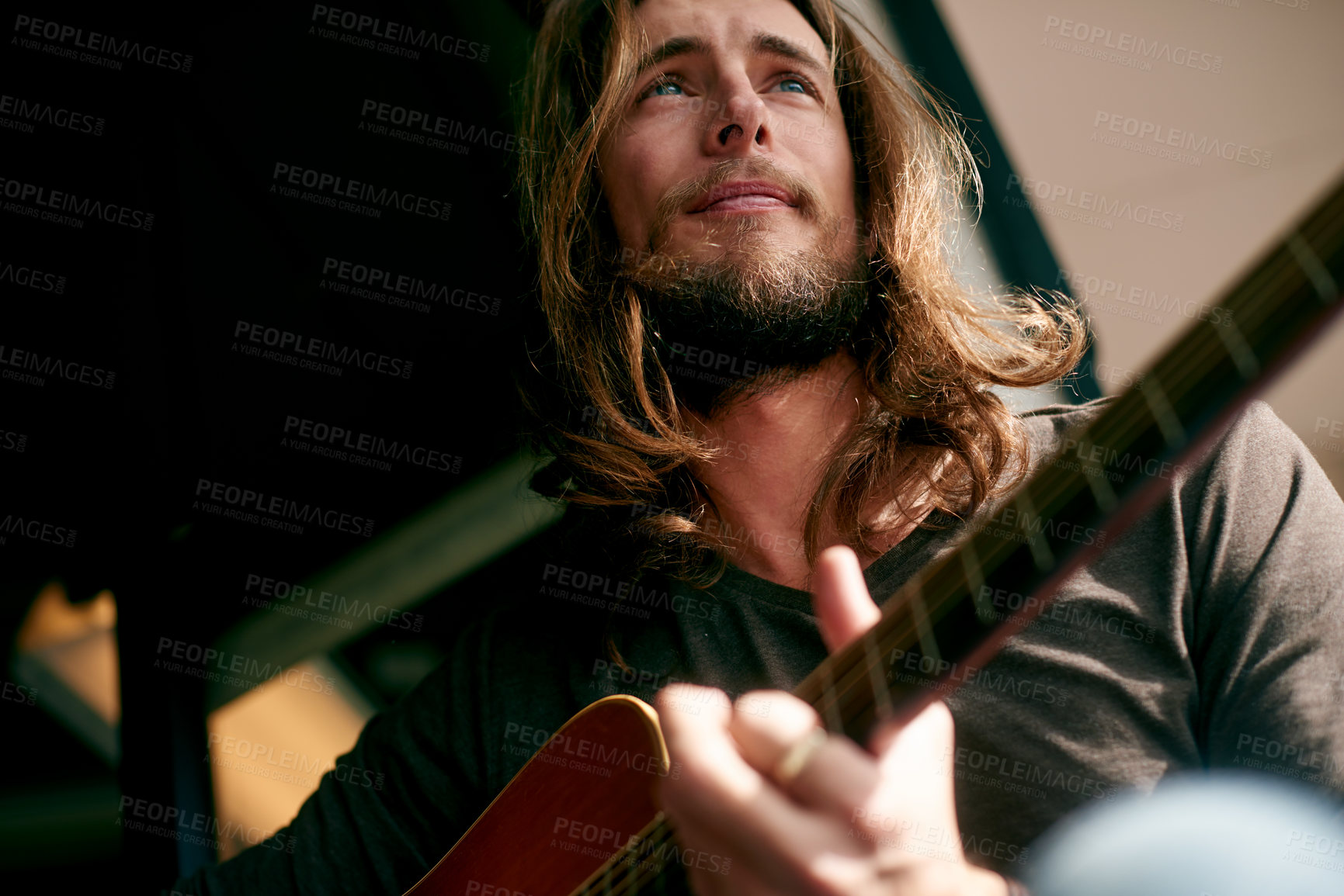 Buy stock photo Man, guitar and thinking with music, creativity and low angle for songwriting process at apartment. Person, musician and artist with string instrument, composer and inspiration for melody at house