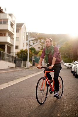 Buy stock photo Travel, adventure and man on bike in city for commuting, journey or carbon footprint on holiday. Street, cycling and person on bicycle for eco friendly transport on vacation in urban town by sunset.