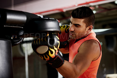 Buy stock photo Boxing, man and punch pad at gym for fight training, sparring and improve coordination. Fitness, technique and professional boxer in health club for conditioning, sports performance and endurance
