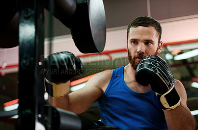 Buy stock photo Punch, strong or man with pads for boxing exercise, development and self defense gym. Fist, athlete and boxer in practice for training technique, learning and fitness workout with fighting skills