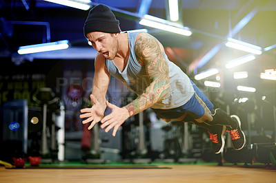 Buy stock photo Fitness, energy or man with jumping push up in gym for muscular power, functional training or action. Night, person and plyometric exercise at sports club for core stability and athletic performance