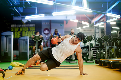 Buy stock photo Fitness, man and kettlebell plank in gym for core strength, weight training exercise and endurance. Balance, athlete and equipment at sports club for night workout, coordination or muscle development