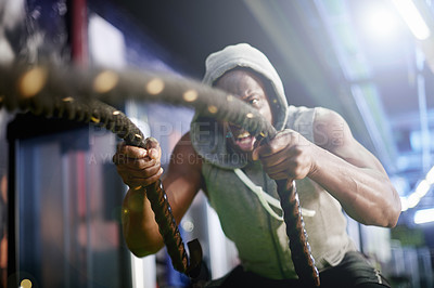 Buy stock photo Black man, workout and battle rope at gym for muscle, development and power with exercise for growth. Intense, training and person with strong arms, fitness and endurance for progress at health club