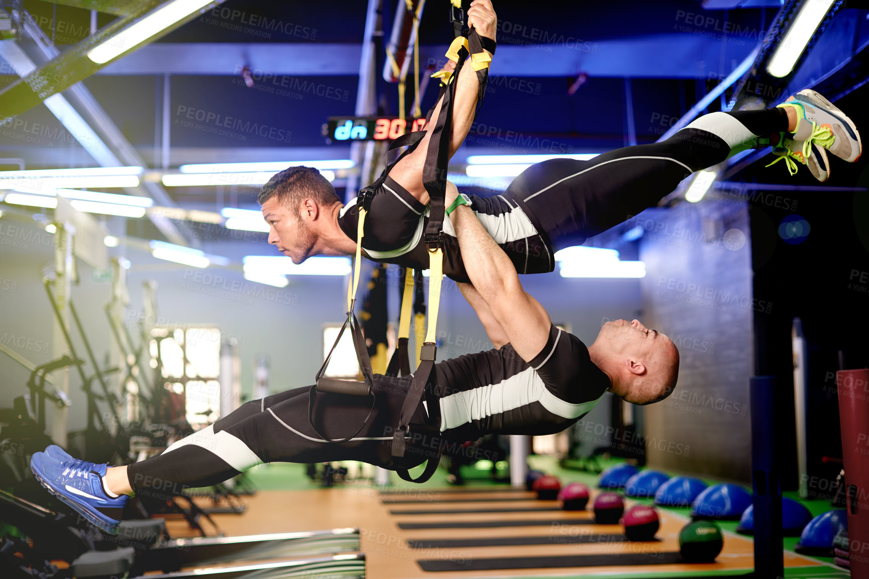 Buy stock photo Fitness, center or people with bungee exercise for resistance training, balance or muscle strength. Professional, athlete or harness equipment at sports gym for acrobatic workout, teamwork and trust