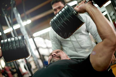 Buy stock photo Personal trainer, weights and men in gym with dumbbell for exercise, fitness and bodybuilder training. Sports, coach and people with equipment for bench press, muscle strength and workout challenge