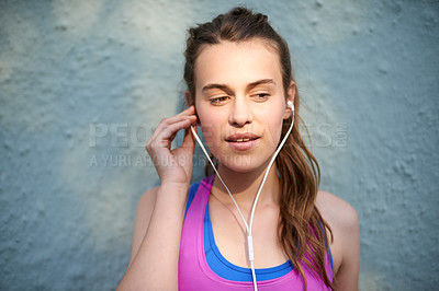 Buy stock photo Teenager, music and earphones with girl on wall background for streaming, audio playlist and podcast entertainment. Sound, media and radio platform with young person listening outdoors to album