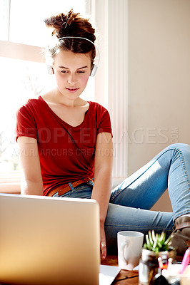 Buy stock photo Girl, relax and laptop with headphones at house for listening to music, streaming podcast and browsing. Female teenager, online and watching movie, website connection and entertainment subscription