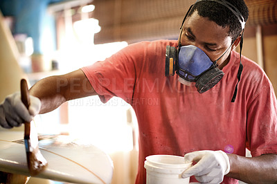Buy stock photo Mask, brush and black man with surfboard, resin and creative for talent and hobby skills. Craftsman, artist and fiberglass with workshop PPE for design, manufacturing or custom work for artisan craft