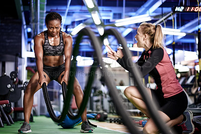 Buy stock photo People, coach and battle rope at gym with exercise, workout and bodybuilding performance. Women, equipment and resilience with personal trainer for motivation, muscle growth and endurance challenge
