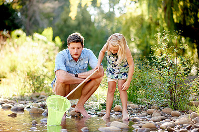 Buy stock photo Nature, travel and girl with dad, net and adventure for holiday or curiosity. Forest, entomology and child with father, pond and conservation or vacation and rocks in woods with learning or explore