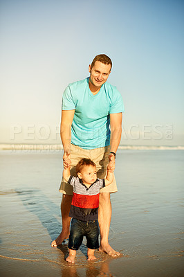 Buy stock photo Dad, baby and portrait at beach, holding hands and happy for learning to walk on vacation in summer. Man, father and toddler son with space, love and smile with bonding on family holiday in Australia