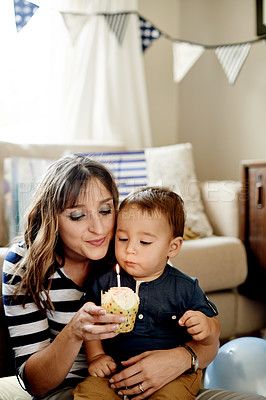 Buy stock photo Birthday, candle or cupcake with mom and son in living room of home together for party. Celebration, dessert or milestone with boy child and single parent woman in apartment for development or growth