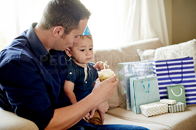 Buy stock photo Birthday, celebration or cupcake with dad and son in living room of home together for party. Candle, dessert or gifts with boy child and single parent man in apartment for development or growth