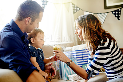 Buy stock photo Birthday, celebration or cupcake with parents and son in living room of home together for party. Candle, dessert or milestone with boy child, mom and dad in apartment for development or growth