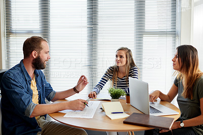 Buy stock photo Collaboration, documents and laptop with designer people in office together for creative brainstorming. Computer, conversation and paperwork with employee team in workplace meeting for strategy