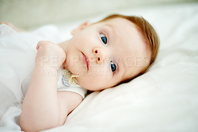 Buy stock photo Thinking, calm and infant rest on bed for cognitive growth, process info and environment in nursery. Comfortable, awake and girl in home with early learning, observe space and relax for development.