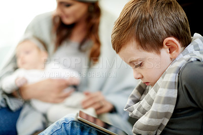 Buy stock photo Tablet, playing and child in home with online gaming for entertainment, growth or development. Digital technology, relax and boy kid watching movie, film or show on app in living room at house.