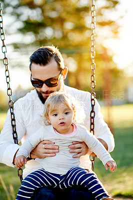 Buy stock photo Nature, swings and dad with kid in park for holiday, weekend or vacation together. Smile, trees and girl child with father for playing outdoor on playground for connection in summer in backyard.