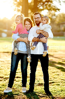 Buy stock photo Portrait, parents and children in park with smile, bonding and relax for summer holiday and vacation. Happiness, man and woman in nature with sunshine, garden and flare in outdoor on weekend.