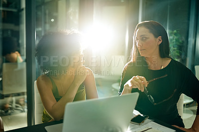Buy stock photo Women, discussion and laptop at office, night and team with review, lens flare and planning at company. People, designer and talk with computer, graphs or feedback with web traffic at creative agency