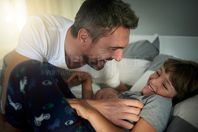 Buy stock photo Morning, playful or tickle with father and son in bedroom of home together for bonding or fun. Happy, laughing or love with boy child and single parent man on bed in apartment for weekend wake up