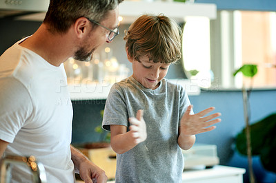 Buy stock photo Baking, bonding and father with child in kitchen in home with learning, fun and activity together. Connection, flour and dad with boy kid for cooking recipe in morning for weekend hobby in house.