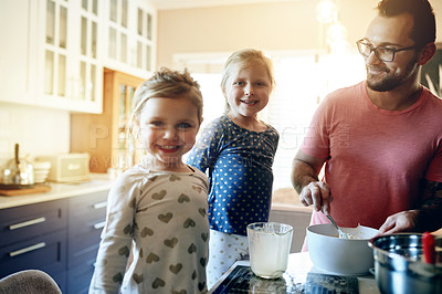 Buy stock photo Father, happy kids and learning to bake in kitchen, help and bonding together with family. Children, smile and baking with parent in home, teaching recipe and dad mix dough with portrait of girls