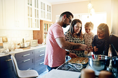 Buy stock photo Baking, help and cupcake with family in kitchen for support, cooking and learning dessert recipe. Teaching, bonding and food with parents and children in home for muffins, love and growth together