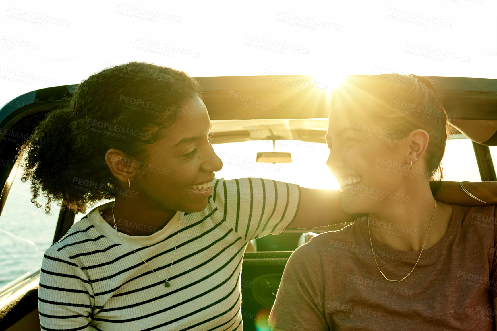 Buy stock photo Sunshine, lesbian and couple in car on road trip for summer holiday, vacation and adventure in vehicle. Dating, lgbtq relationship and happy women for bonding on journey, tourism or travel with flare