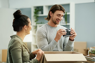 Buy stock photo New house, happy and couple with box for moving to home, property mortgage and real estate purchase. Homeowner, excited and man with woman for relocation, rental apartment and packing furniture