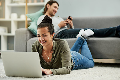 Buy stock photo Laptop, relax and typing with woman on floor in living room of home to search for movie review. Break, computer and man on phone with couple in apartment together for me time or wellness on weekend
